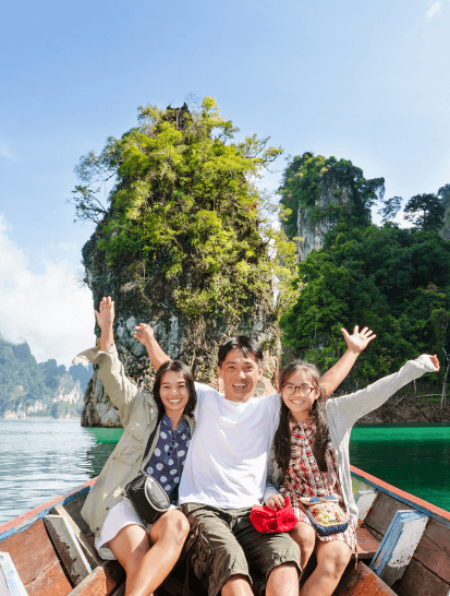three people enjoying a boat ride on a tropical lake