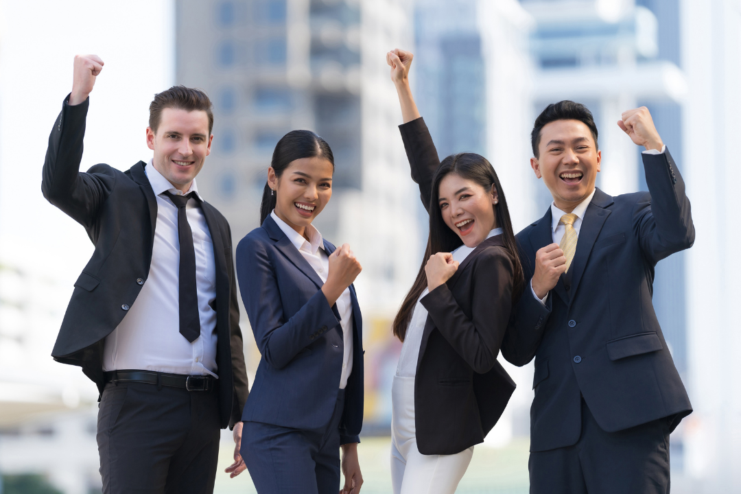 a group of businessmen and women cheering