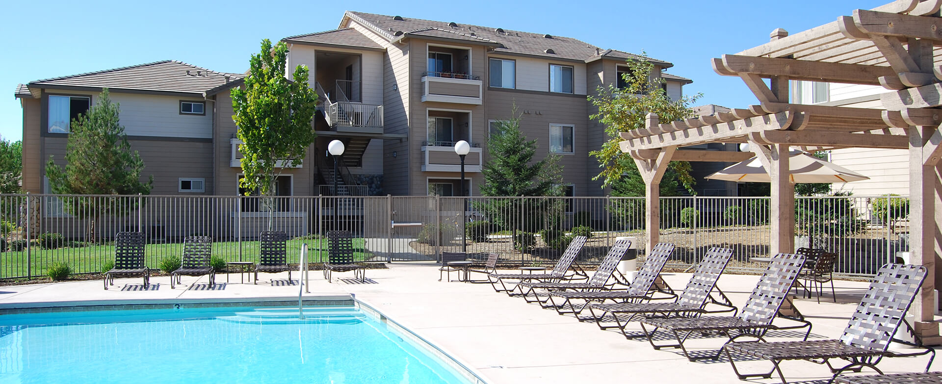 Community pool with a gazebo and chairs